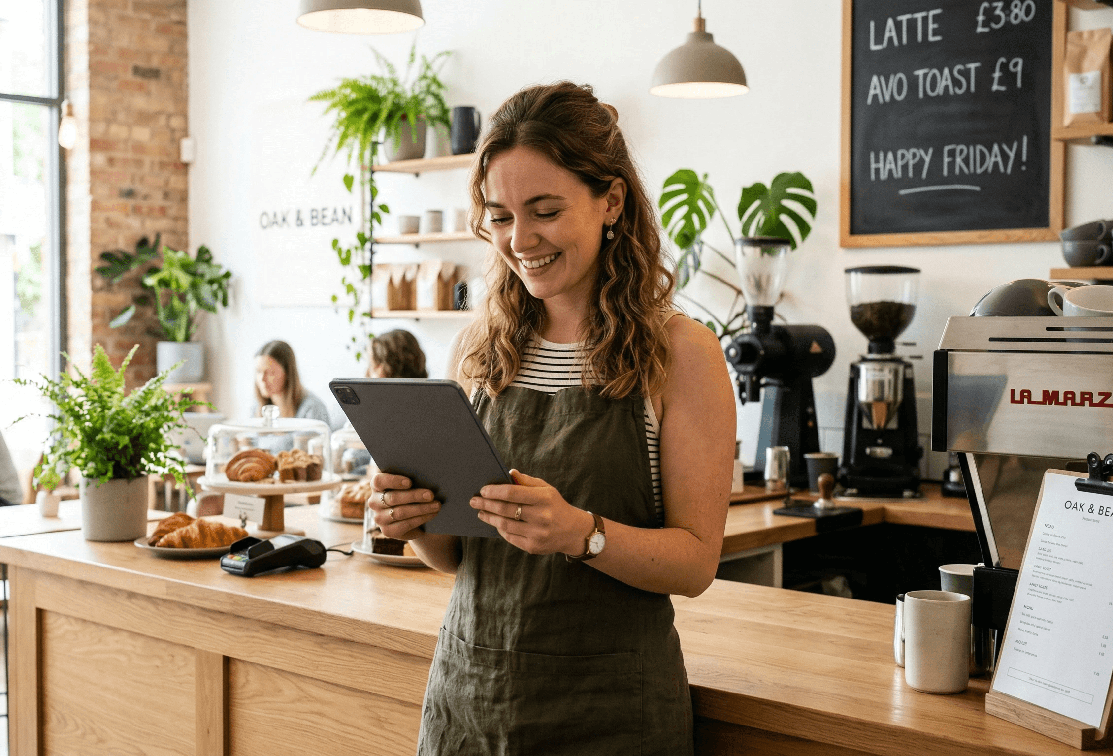Café owner reviewing Square data on a tablet